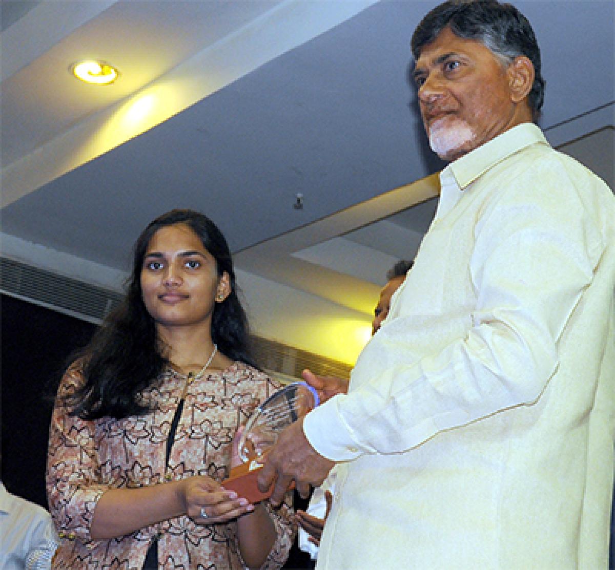 Chief Minister presenting a memento to Code for AP software programmer Shreya at the CII conference 